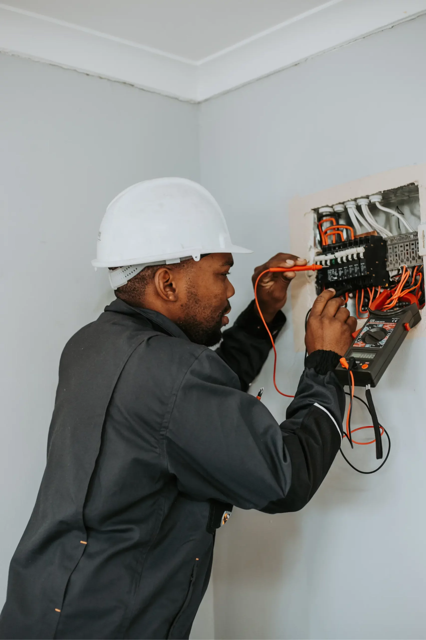 Electrical contractor conducting electrical installation testing and inspection on a residential distribution board in Cape Town